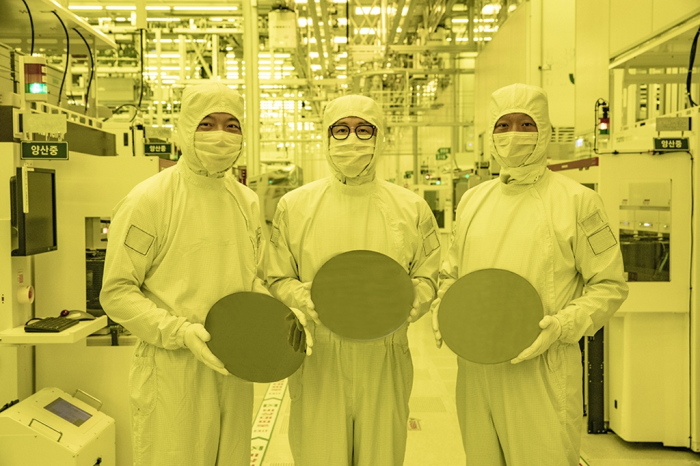 Samsung executives hold semiconductor wafers made with 3-nanometer tech
