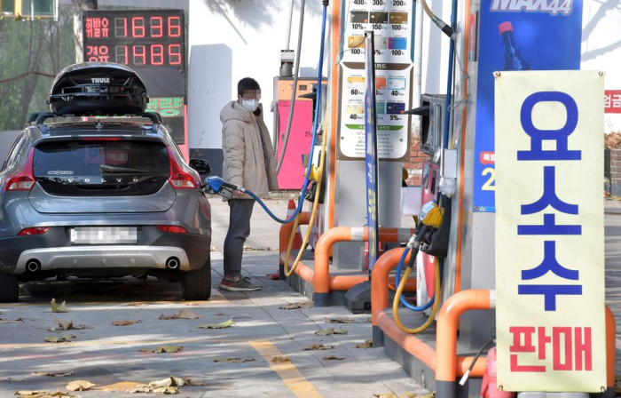 A gas station in Seoul posts a notice that it sells DEF or diesel exhaust fluid