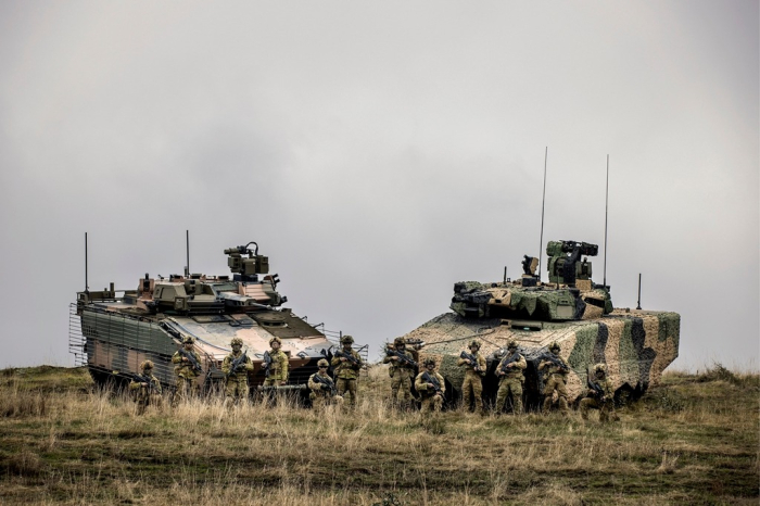 Australian soldiers stand in front of Hanwha's Redback IFV (left) and Rheinmetall's Lynx KF-41 IFV (File photo, courtesy of Australian Department of Defence)
