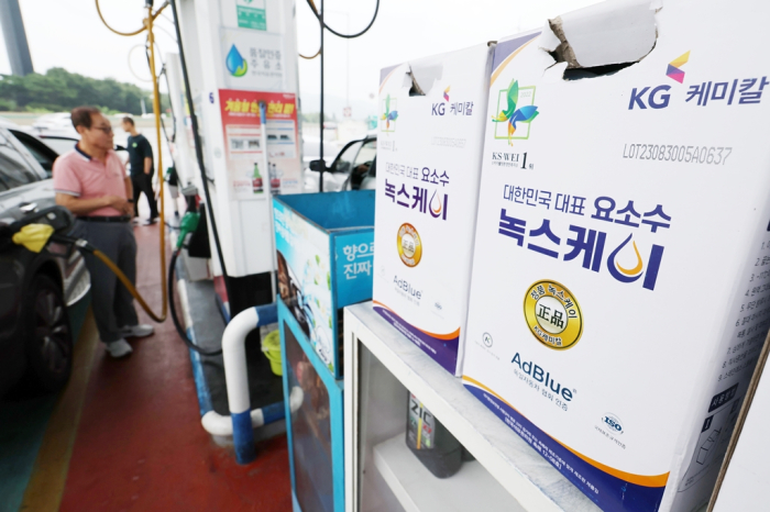 KG Chemical's DEF or diesel exhaust fluid products stacked at a gas station in Seoul
