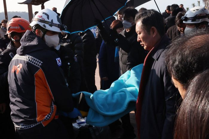 Lee Jae-myung is carried on a stretcher after the attack, which is being treated as a premeditated crime. PHOTO: AGENCE FRANCE-PRESSE/GETTY IMAGES