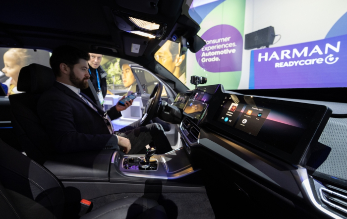 A　visitor　tests　Harman's　Ready　Care　system　showcased　at　CES　2024
