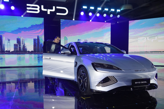 An　attendee　inspects　a　BYD　Seal　electric　car　during　a　launch　event　in　Jakarta　on　Jan.　18,　2024.　China's　top　EV　maker　BYD　launched　three　models　Atto　3,　Seal　and　Dolphin　in　Indonesia　(Courtesy　of　AP,　Yonhap)