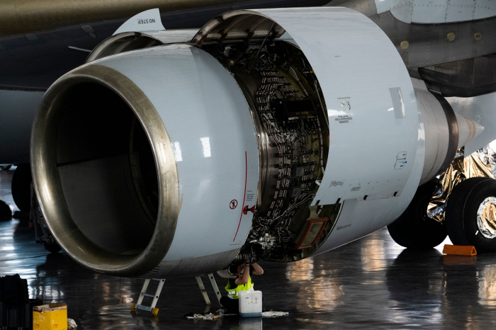A Korean Air engineer works on an aircraft engine