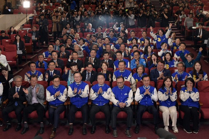 Democratic Party members cheer the results of the April 10 elections