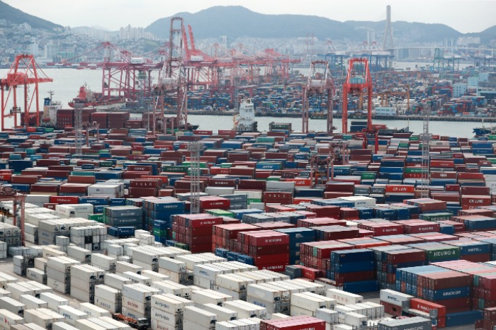 Stacked containers await loading onto ships at a South Korean port