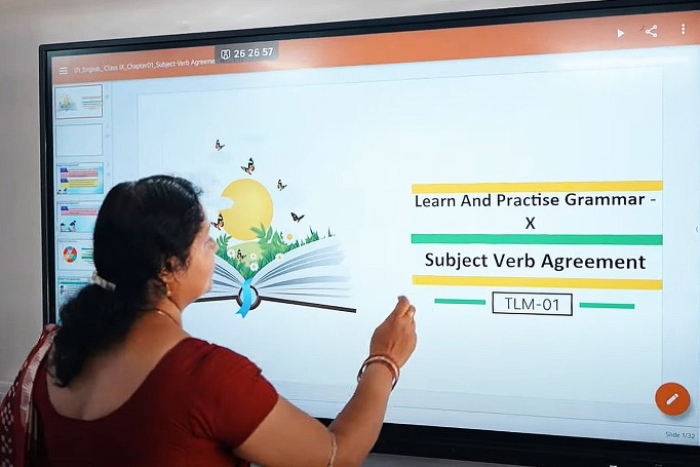 A teacher is conducting a class, using LG's electronic whiteboard, at a public high school in Laksheswar, India (Courtesy of LG Electronics)