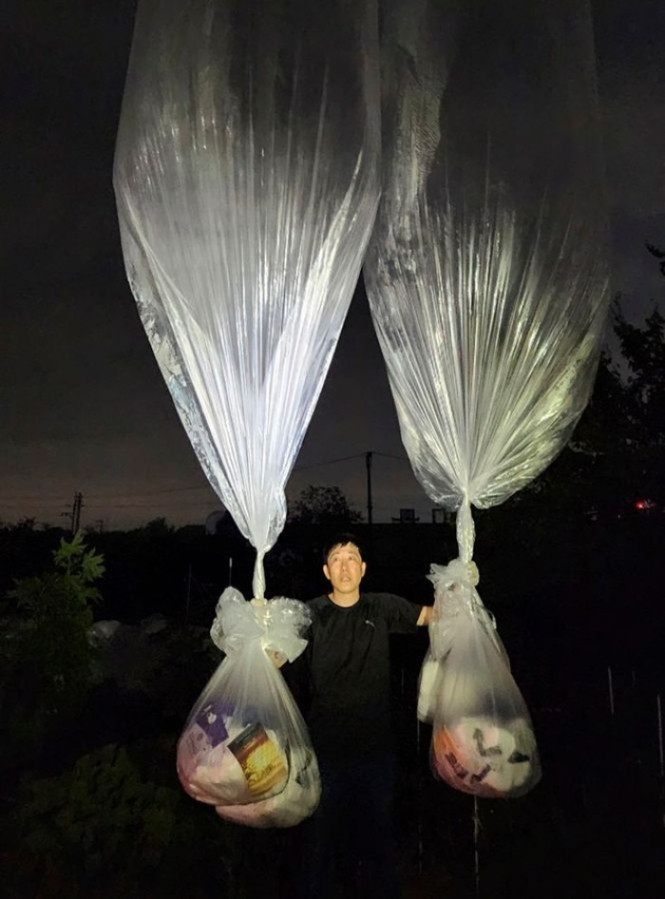 North Korean defector Park Sang Hak, holding a banner attached to a balloon, has sent balloons into North Korea that carry messages against its leader Kim Jong Un and others that carry medical supplies.FIGHTERS FOR A FREE NORTH KOREA/ASSOCIATED PRESS