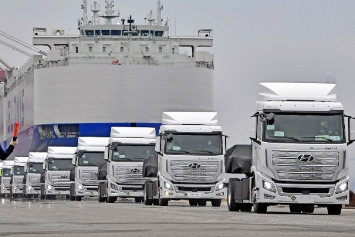 Car carrier trailers head back after unloading cars onto a Hyundai Glovis ship