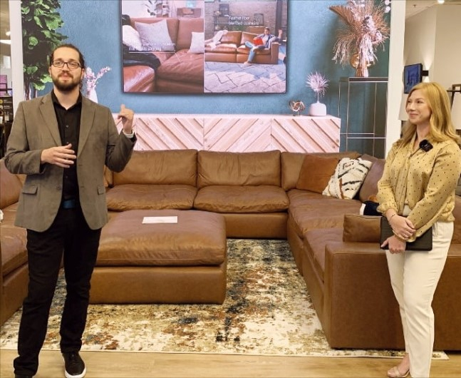 A Samsung home entertainment employee (left) and an Ashley product manager present Samsung's SmartThings IoT platform at the Samsung SmartThings Home at Ashley store near Nashville, Tennessee
