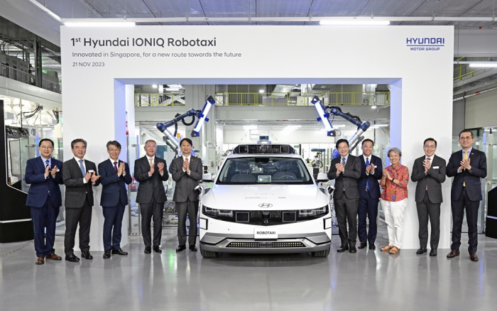 Hyundai Motor Chairman Chung Euisun (fourth from left) and company executives with an IONIQ 5 robotaxi at the ceremony commemorating the completion of the automaker's Singapore plant, HMGICS, in November 2023