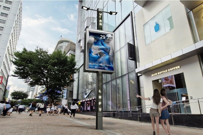 A media pole in Myeong-dong Square, a shopping district