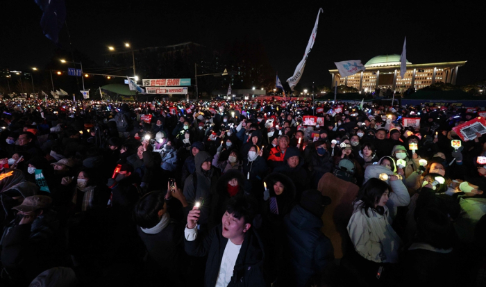 Protesters taking part in a rally calling for the impeachment of South Korean President Yoon Suk Yeol, near the National Assembly in Seoul