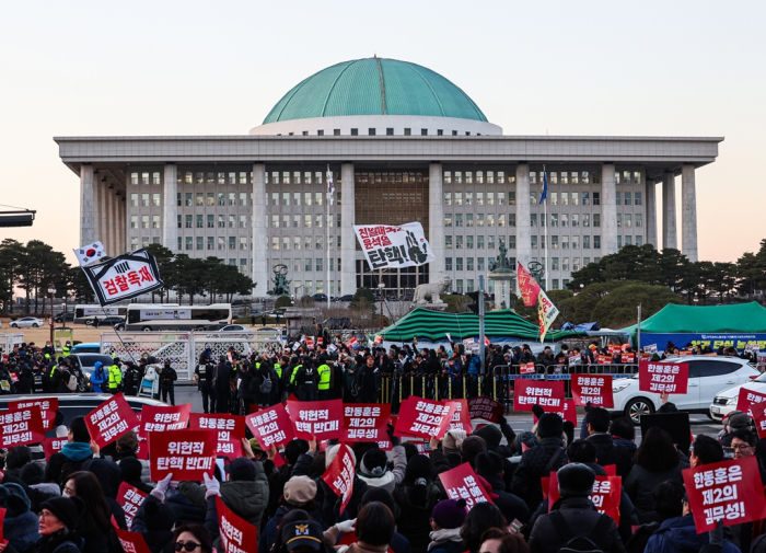 Protesters taking part in a rally calling for the impeachment of South Korean President Yoon Suk Yeol, near the National Assembly in Seoul