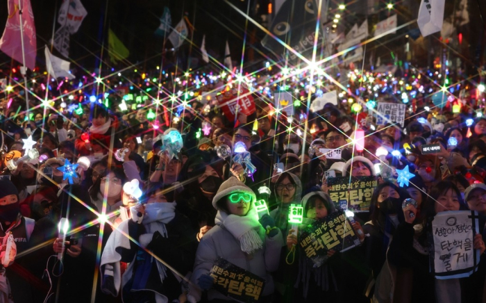 Protesters cheer outside the National Assembly after the impeachment of President Yoon was announced on Dec. 14, 2024 (Courtesy of Yonhap)