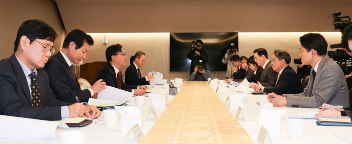 Kim Beom-seok (third from left), first vice minister of economy and finance, chairs an emergency economic meeting to announce measures to ease Korea's forex regulations