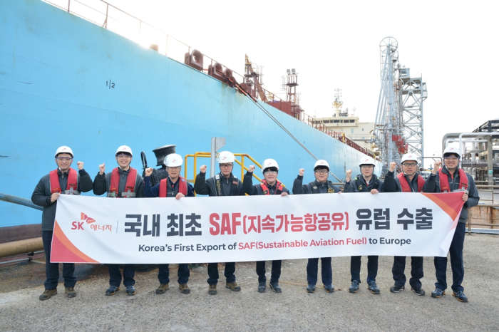 SK Energy officials bearing a banner celebrating the refiner’s first SAF export to Europe pose for a photo in the southeastern port city of Ulsan, Korea