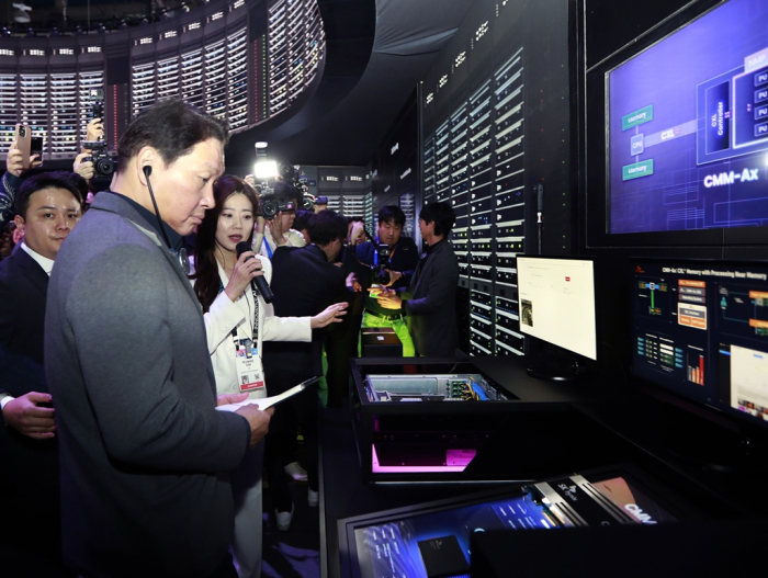 SK Group Chairman Chey Tae-won (front) visits booths at CES 2025