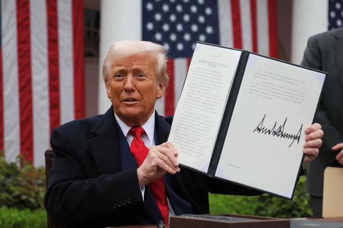 US President Donald Trump holds a signed executive order on tariffs in the Rose Garden at the White House in Washington, D.C. on April 2, 2025 (Courtesy of Reuters via Yonhap)