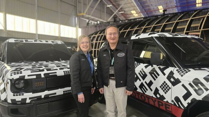 Slate Auto CEO Chris Barman (left) and SK On CEO Lee Seok-hee pose for a photo at a Slate electric pickup truck unveiling event in Long Beach, California