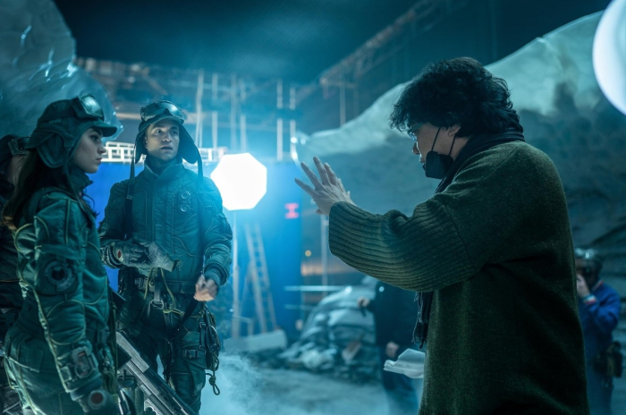 Director Bong Joon Ho on set with actors during the filming of 'Mickey 17' (Courtesy of IMDb)