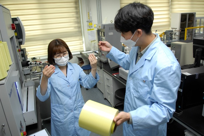 Kolon Industries employees inspect para-aramid products 