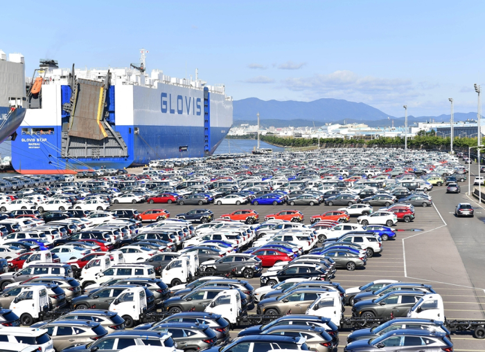 Hyundai Motor vehicles for export are loaded onto a Hyundai Glovis car carrier ship at a seaport in Ulsan, South Korea