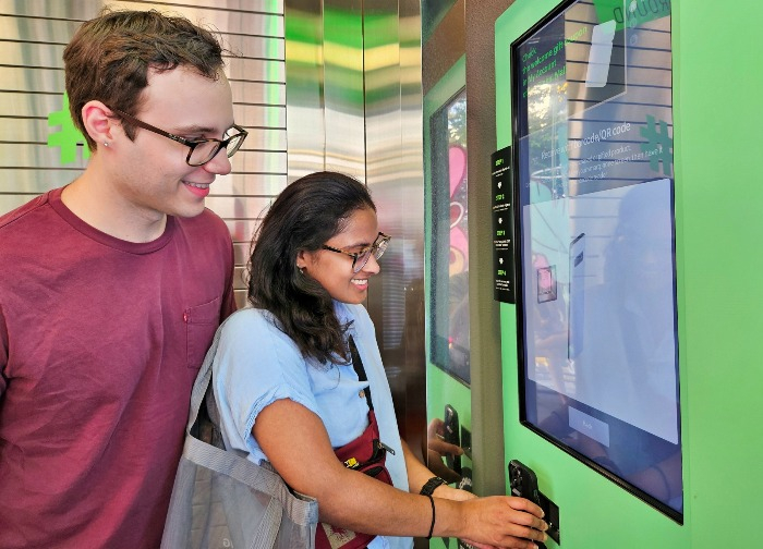 Olive Young shoppers use a kiosk at an Olive Young store in Seoul to sign up for Global Mall membership (Courtesy of Olive Young)