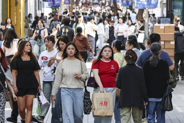 Foreigners walk in Myeong-dong, a favorite spot for travelers in Seoul