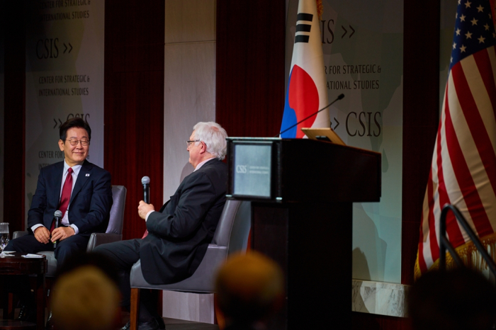 South Korean President Lee Jae Myung (left) chats with John Hamre, CSIS CEO, after delivering a speech at the Center for Strategic and International Studies in Washington, D.C.