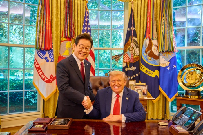 South Korea's President Lee Jae Myung (left) shakes hands with US President Donald Trump in the Oval Office following their summit on Aug. 25, 2025 